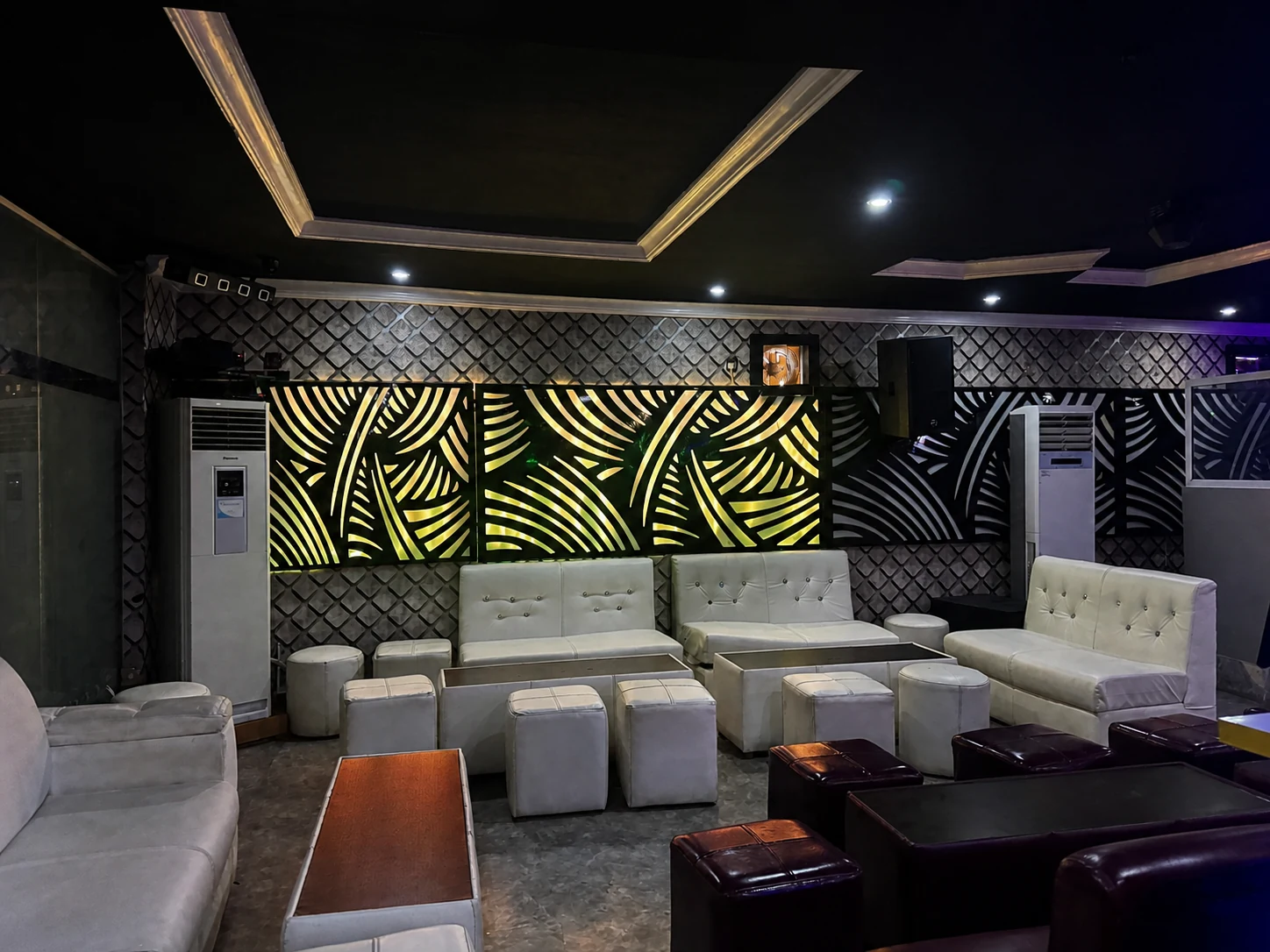 Nightclub seating beneath patterned wall lighting at Arcadia